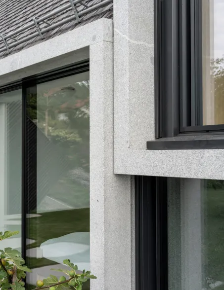 detail of a residential building with modern granite cubes as a central element