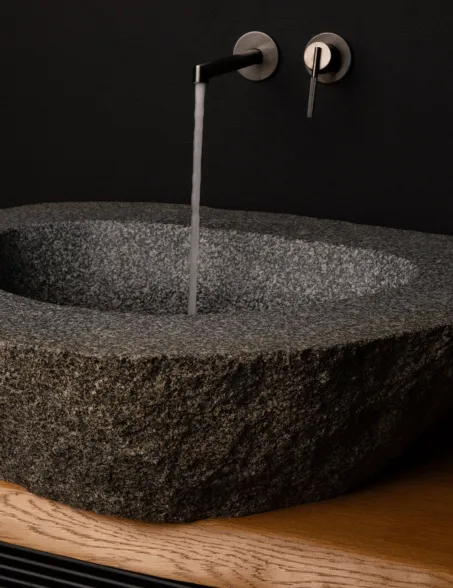 Basin made out of a dark boulder