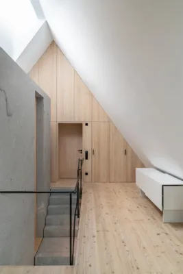 modern attic with view of a solid granite wall and staircase