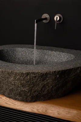 Basin made out of a dark boulder
