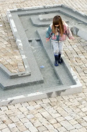 child playing in a water feature