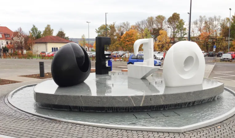 fountain with multiple abstract sculptures made from different natural stones