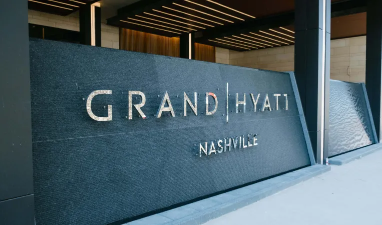 water wall made of dark granite in front of a hotel