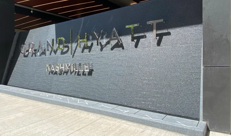 water wall made of dark granite in front of a hotel