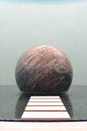 Floating sphere in a basin with stepping stones