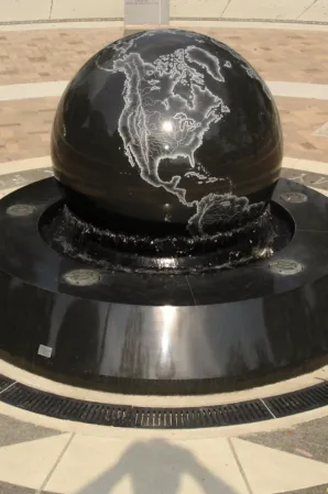 Black granite sphere with engraved world map