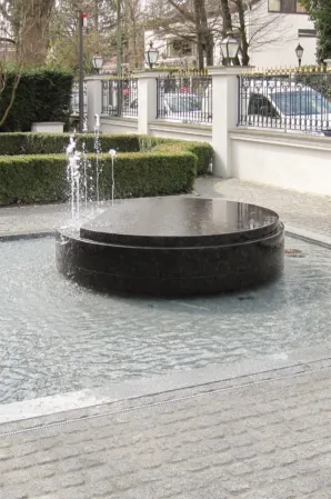 Rotating disc made of black granite with fountains