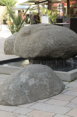 Wobbling boulders in a fountain