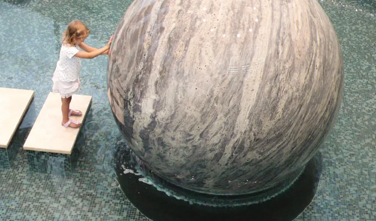 Floating sphere being rotated by a child