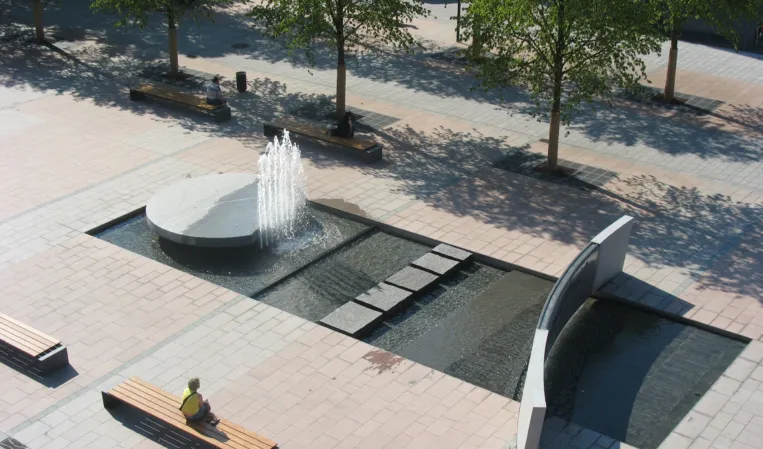 Large fountain installation with rotating disc and large water wall