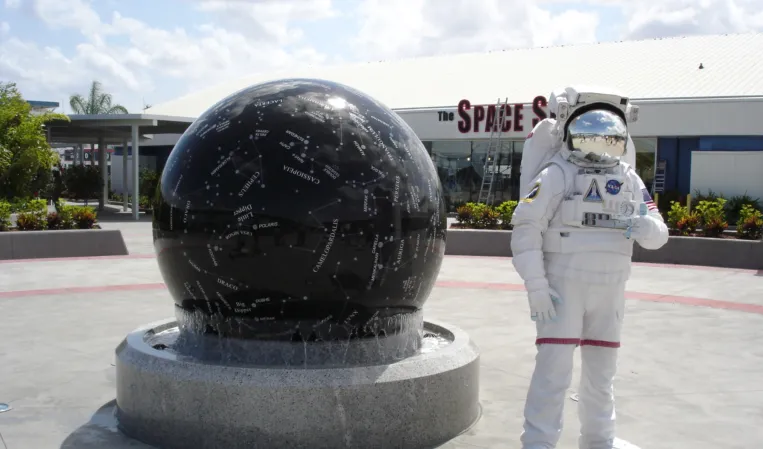 Black granite sphere with engraved constellation and an astronaut beside it