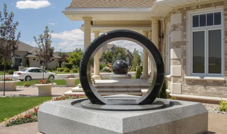 Rotating ring made of black granite in a fountain installation