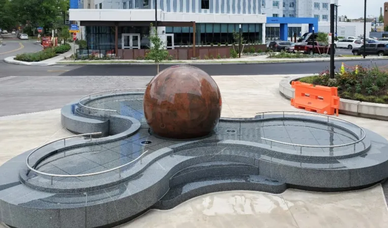 Red granite sphere in a fountain installation