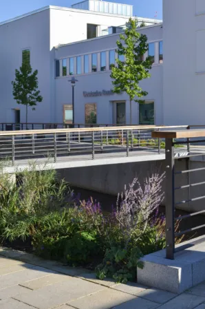 Granite bridge with railing in an urban setting