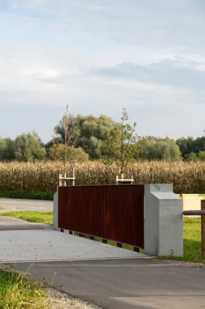 Burgundy railing and granite corner pillar of a bridge