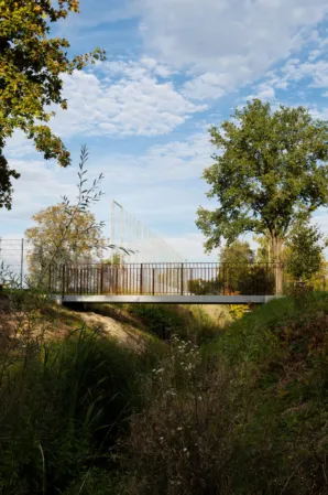 Pedestrian bridge over a natural stream