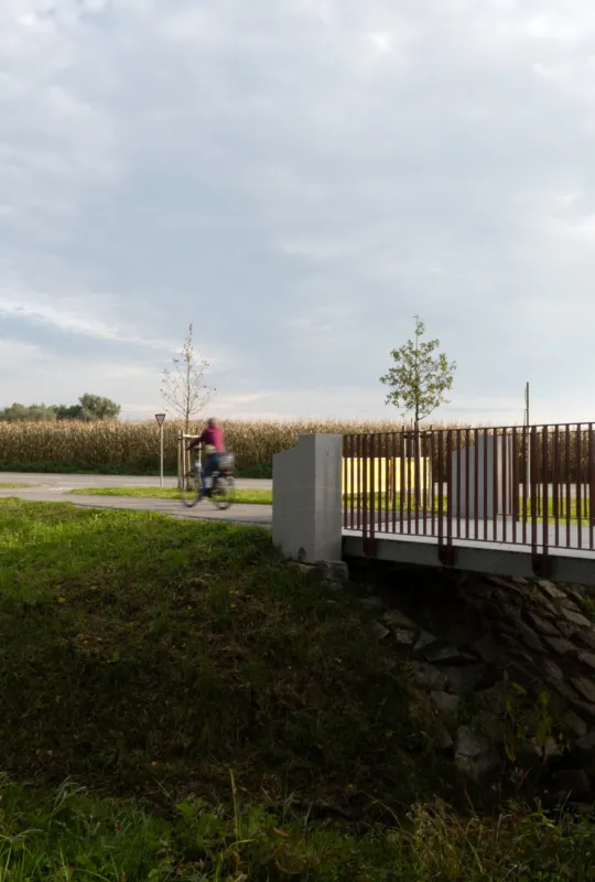 Cyclist riding across the cycle path bridge