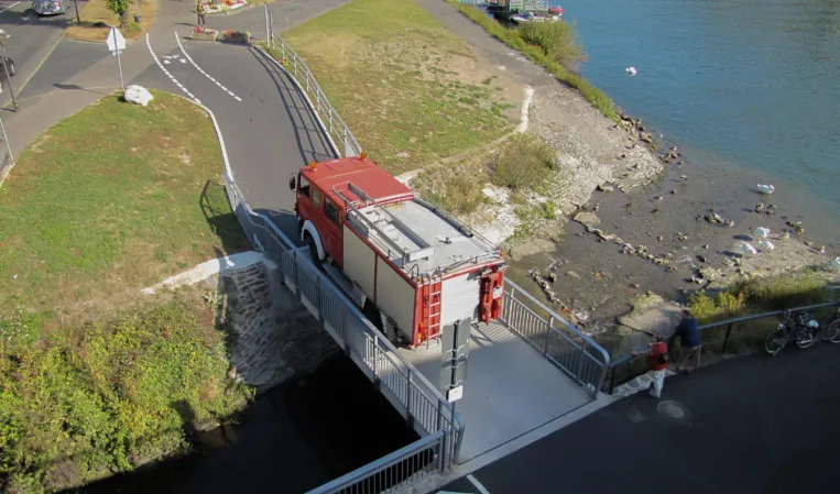 Fire engine driving across a granite bridge