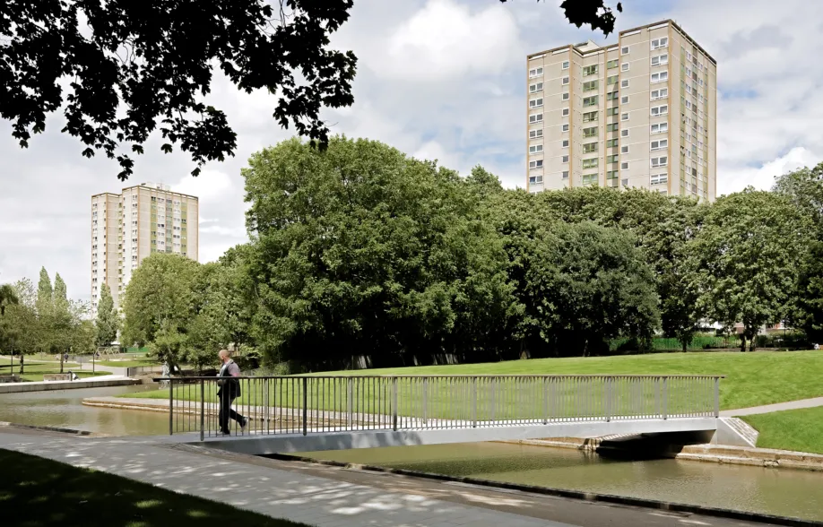 A person walking over a large post-tensioned granite bridge