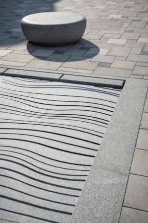 Water jet field made of solid granite with engraved pattern