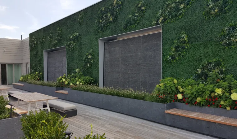 two water wall integrated into a green way full of plants