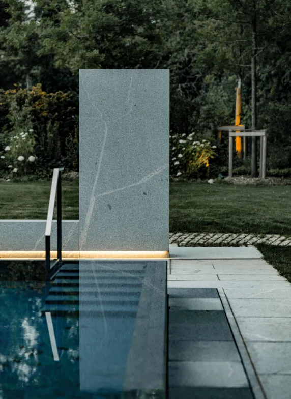 Illuminated outdoor shower made of solid granite