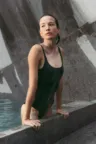 a beautyful woman in a pool made from granite