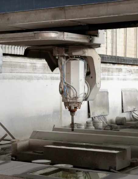 CNC milling machine machining a granite element