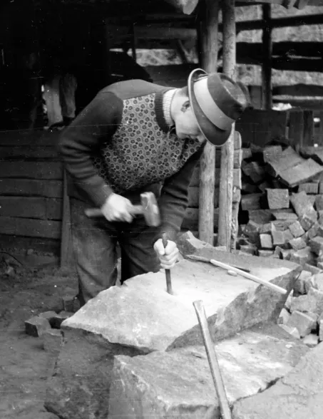 historic black-and-white photograph of a stonemason