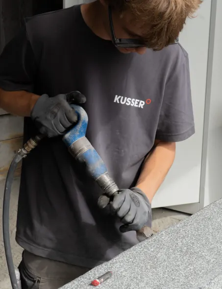 apprentice practicing on a stone workpiece