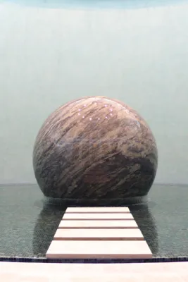 floating sphere made of red granite