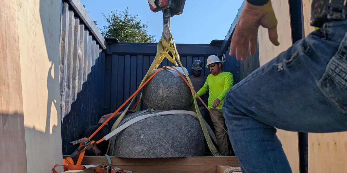 a floating sphere fountain in a container being lifted