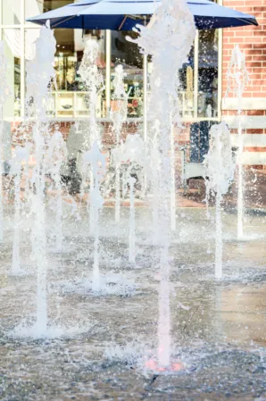 closeup of water jets from an interactive fountain