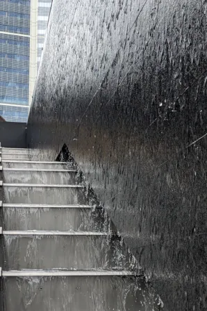 Water flowing over a waterwall into a cascading runnel