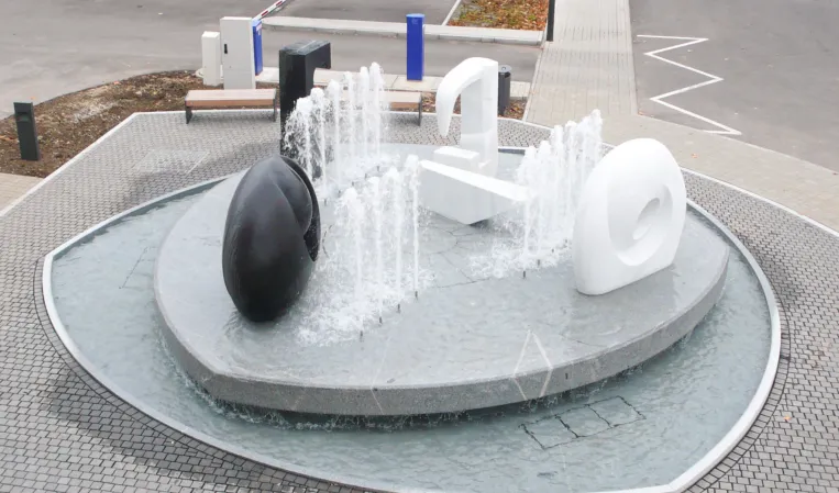 fountain with multiple abstract sculptures made from different natural stones