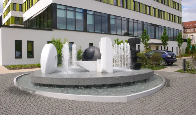 fountain with multiple abstract sculptures made from different natural stones