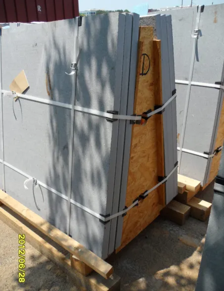 Prefabricated granite slabs secured with metal straps on a wooden pallet