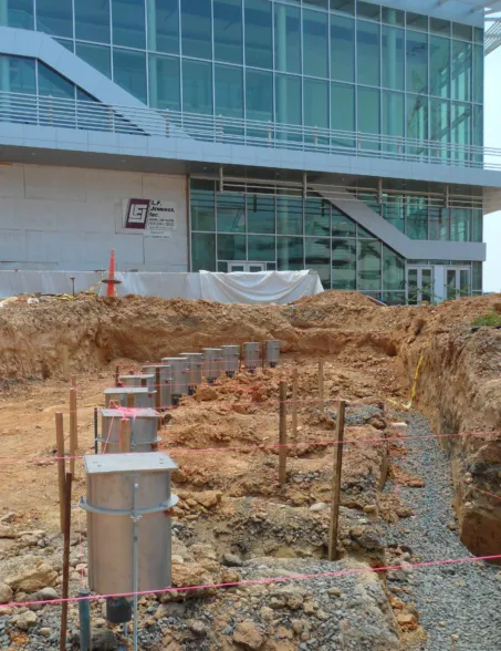 Construction site preparation with foundation trenches and utility connections for a fountain installation
