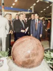 sphere fountain displayed at a trade fair with prominent visitors